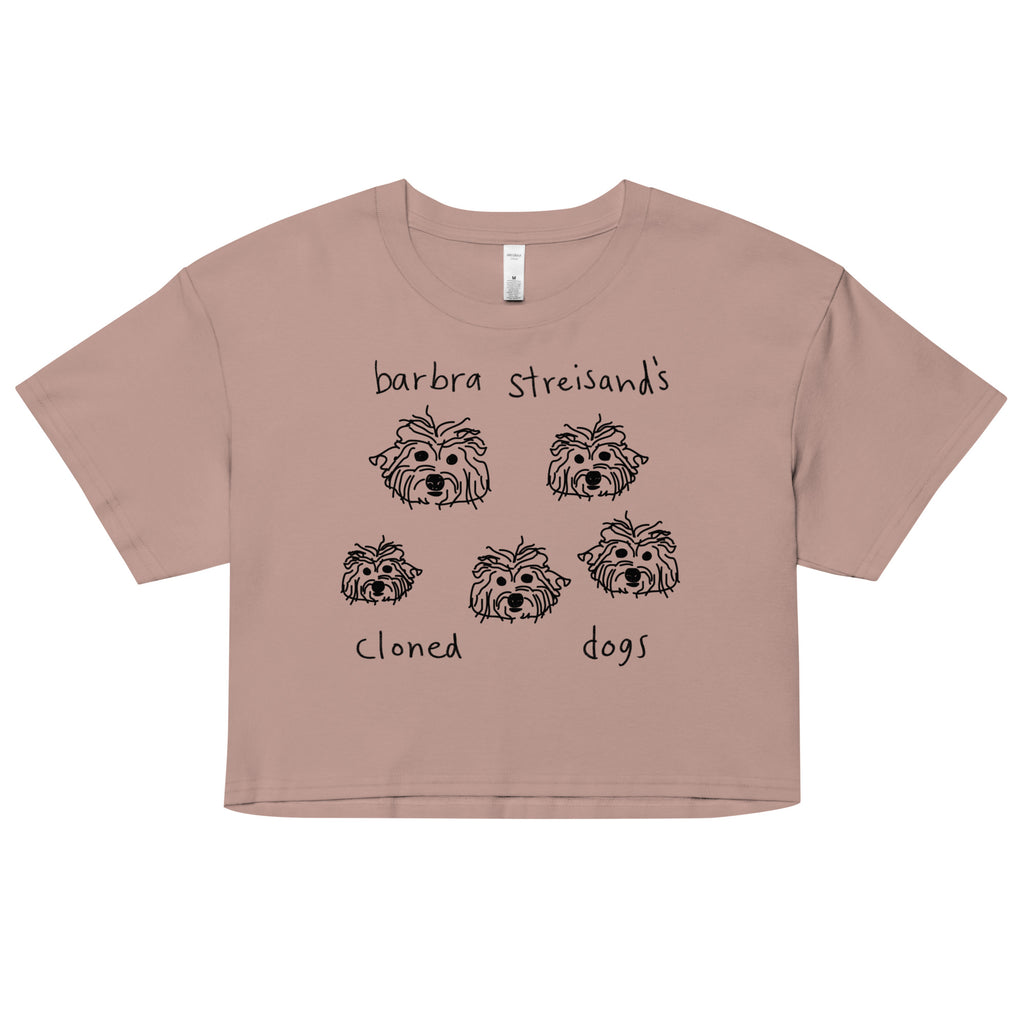 Image of a light mauve crop top that says "Barbra Streisand's Cloned Dogs" and an illustration of 5 similar looking dog heads